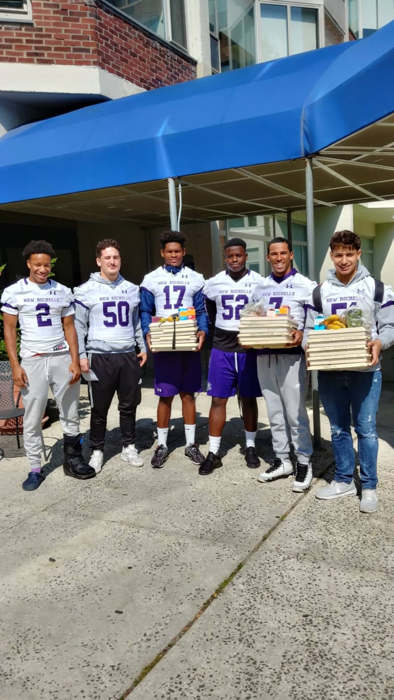 Players from the New Rochelle Varsity football team delivering meals to patients at Montefiore Hospital earlier this year.