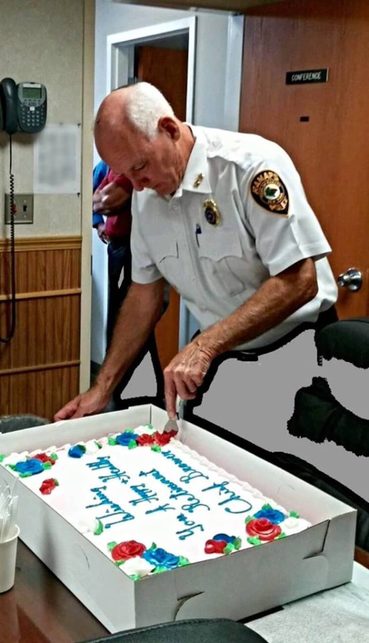 Ramapo police Chief Peter Brower cuts a cake at his retirement party.
