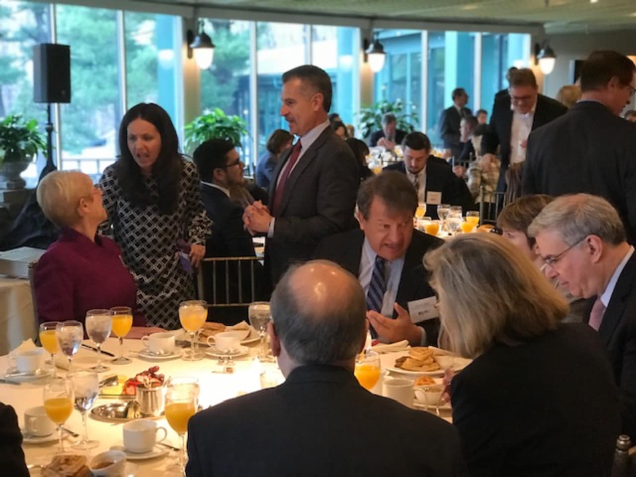 Westchester County Executive George Latimer, seated, chats with business leaders before a speech on Wednesday. Marsha Gordon, president/CEO of the Business Council of Westchester, is seated on the left.
