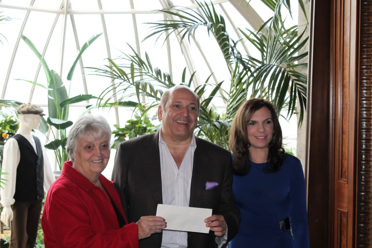L-r: Lockwood-Mathews Mansion Museum board chairman Patsy Brescia, Klaff’s CEO Joe Passero, and the museum's executive director, Susan Gilgore, show off the check for $8,811.90 that the design firm donated to the museum