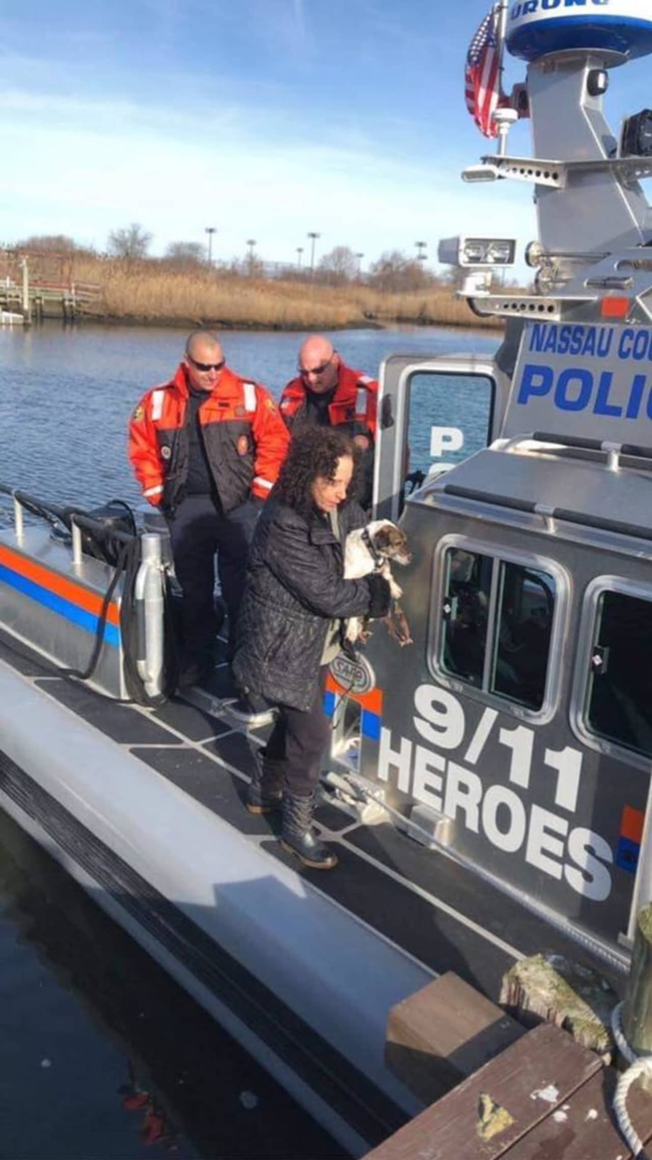 The officers return a dog who was drowning to its owner after rescuing the pup.