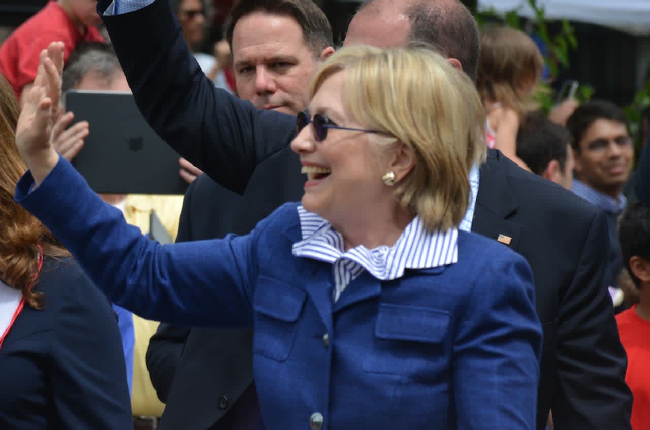 Hillary Clinton waves as she marches in the town of New Castle's 2016 Memorial Day parade, which went through downtown Chappaqua.