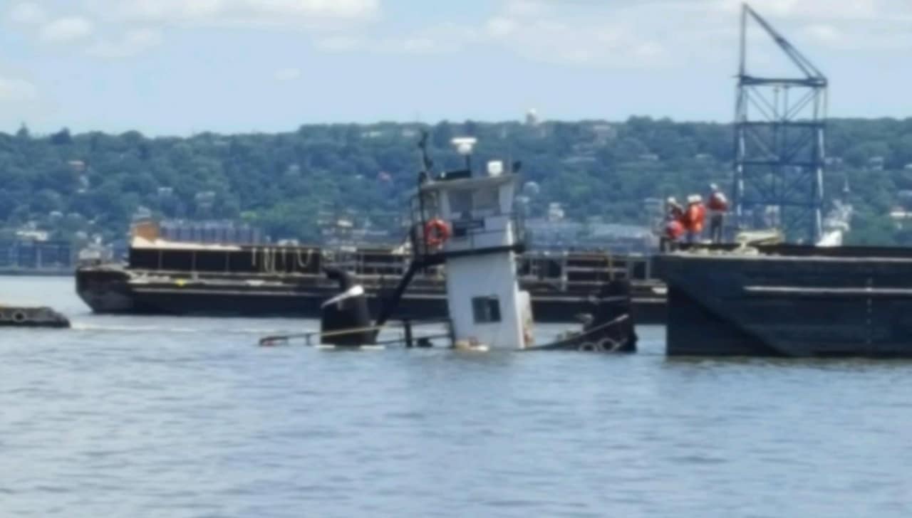 A tugboat sinks in the Hudson River near the Tappan Zee Bridge early Thursday afternoon.