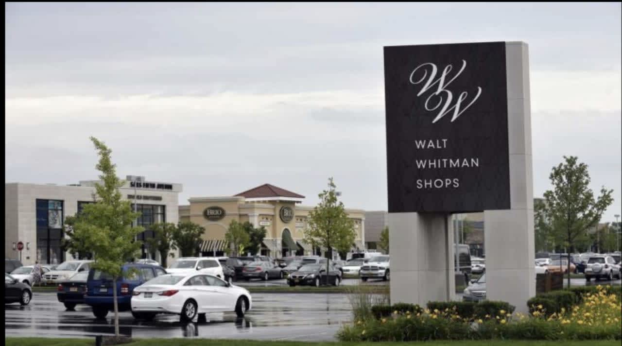 A police officer and two others were injured during a crash in front of Walt Whitman Mall.