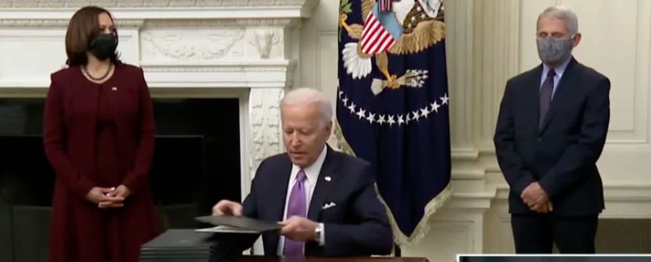 President Biden signed 10 COVID-related executive orders on his first full day in office, Thursday, Jan. 21, as Vice President Kamala Harris and Dr. Anthony Fauci looked on.