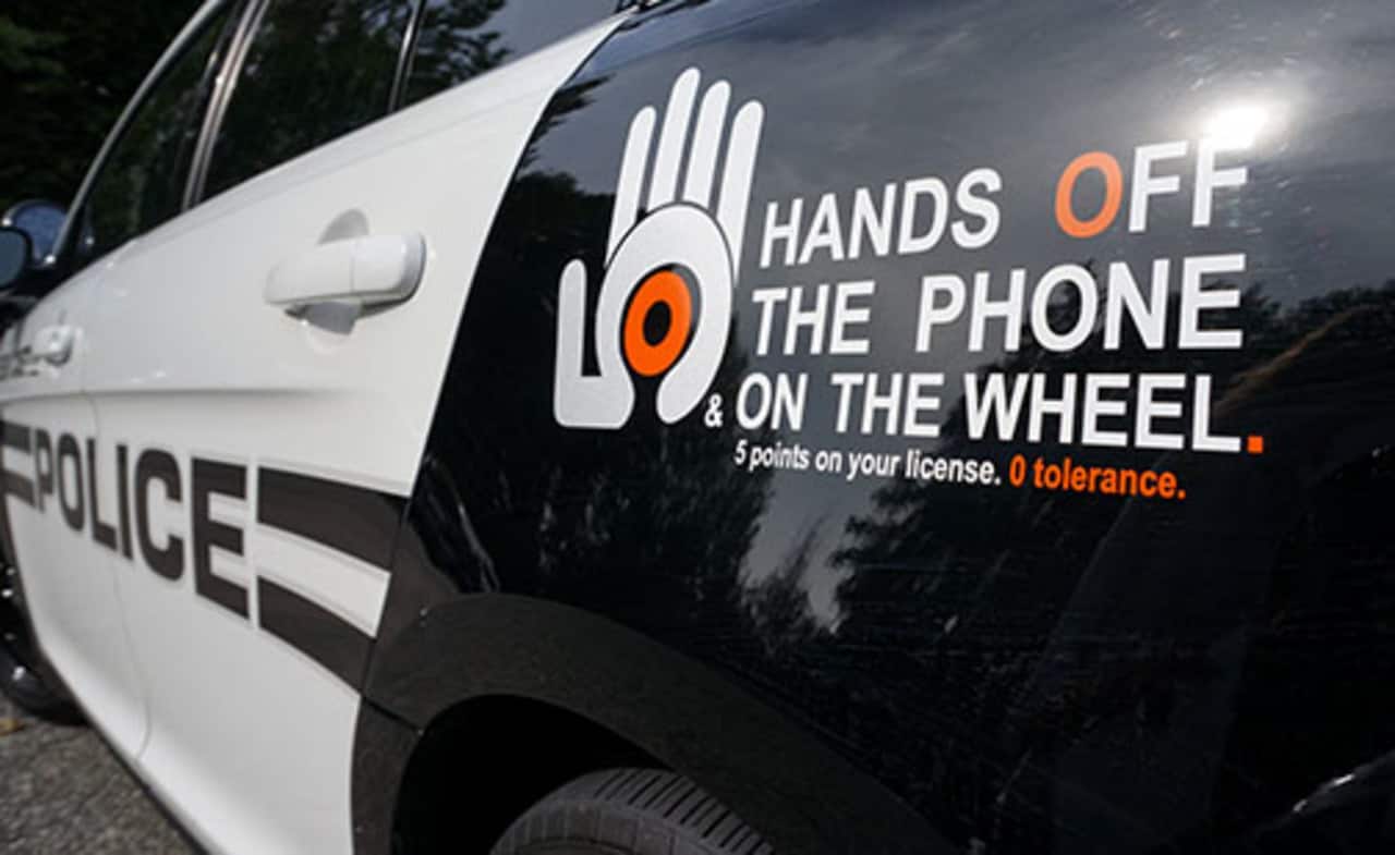 An anti-distracted decal is displayed on a New Castle police car.