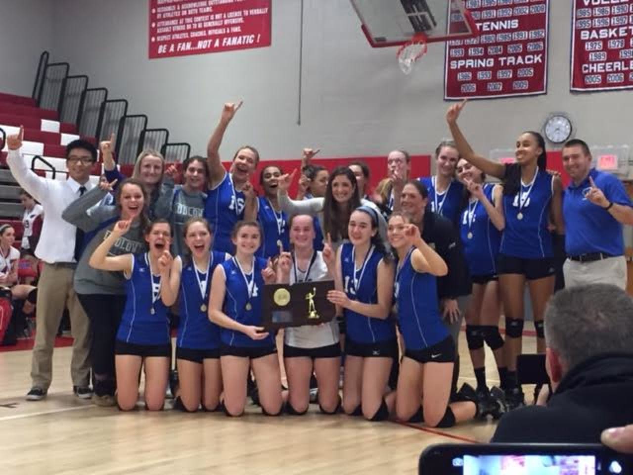 The girls volleyball team from Fairfield Ludlowe High celebrates after winning the state title.
