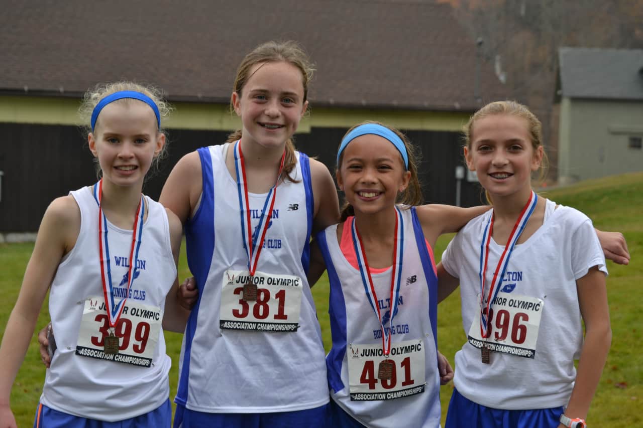 Wilton Running Club teammates (left to right) Angela Saidman,  Cora Creighton, Emily Welch and Tess Pisanelli finished in the top 10 in their division in Sunday's race.