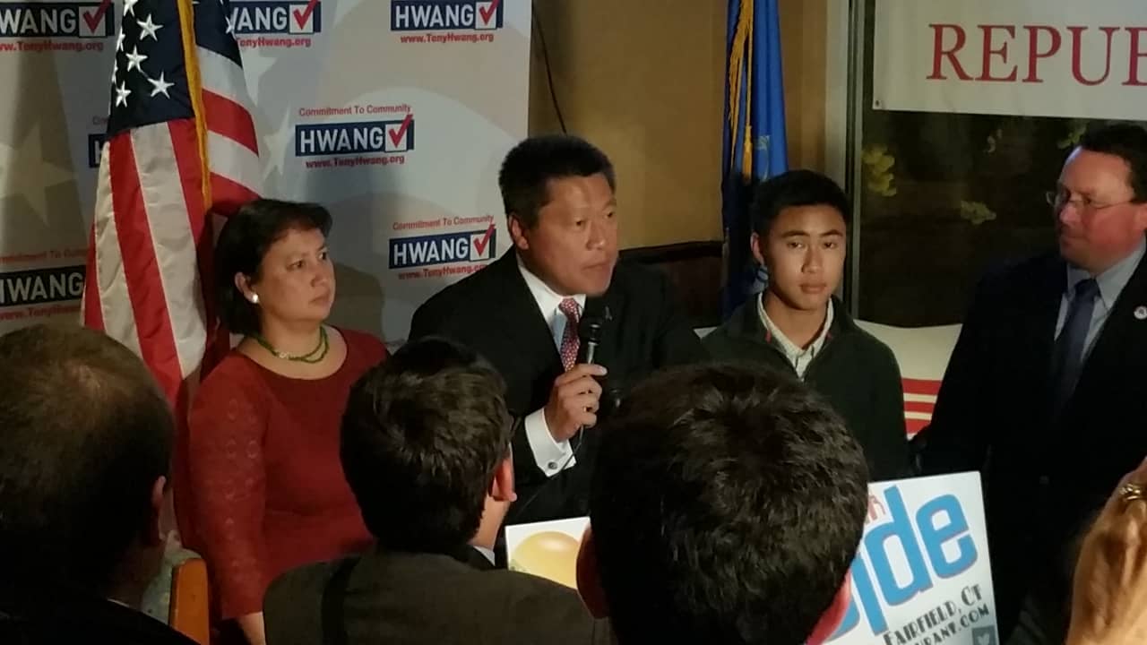 Tony Hwang (center) with his wife and son at Flipside Burgers and Bar, where he gave his victory speech to a crowd of family, friends and supporters Tuesday night.