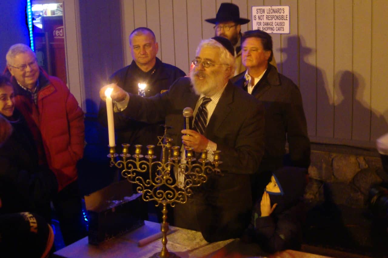 Circle of Friends, a volunteer group that serves people with special needs, is holding a Hanukkah festival Tuesday, Dec. 8, at Beth Israel of Westport/Norwalk. Rabbi Yehoshua Hecht of Beth Israel  lights candles on the menorah.