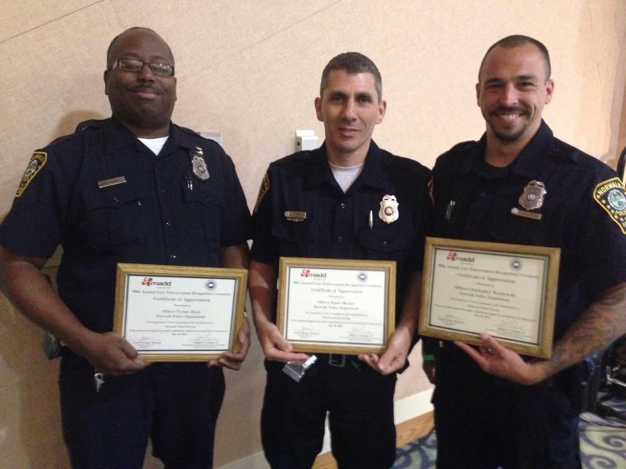 From left, Norwalk Police Officers Tyrone Boyd, James Mosher, and Christopher Wasilewski.