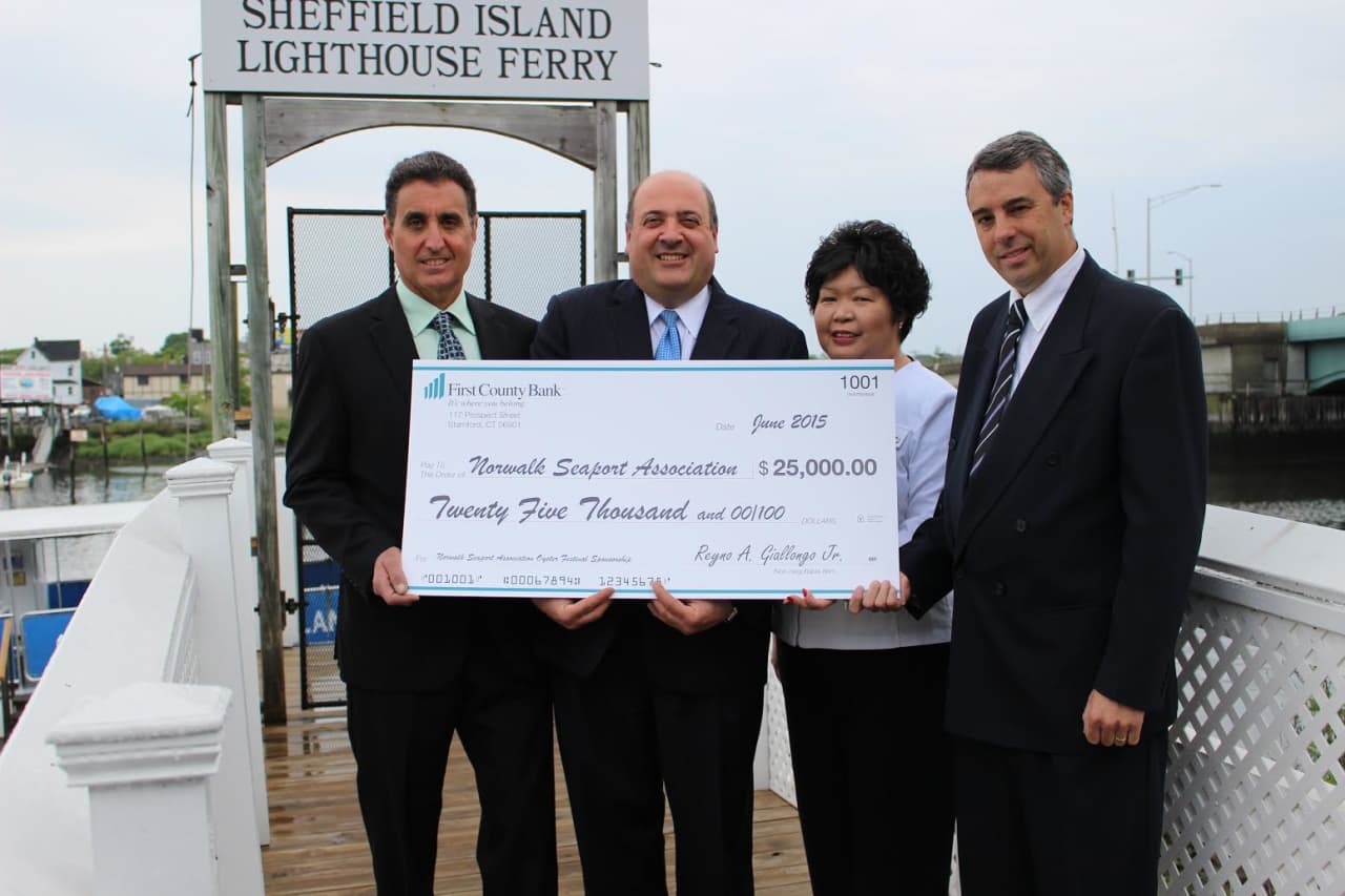 The big check is presented on the dock! See story for IDs. 