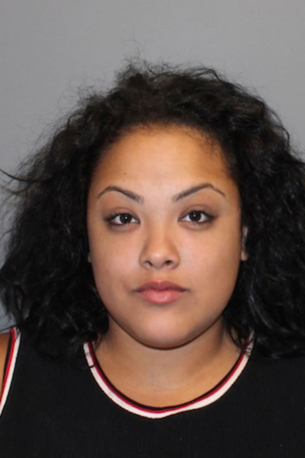 Ashely Aponte, 21, of Norwalk was charged with throwing a bottle at a car and kicking an officer.