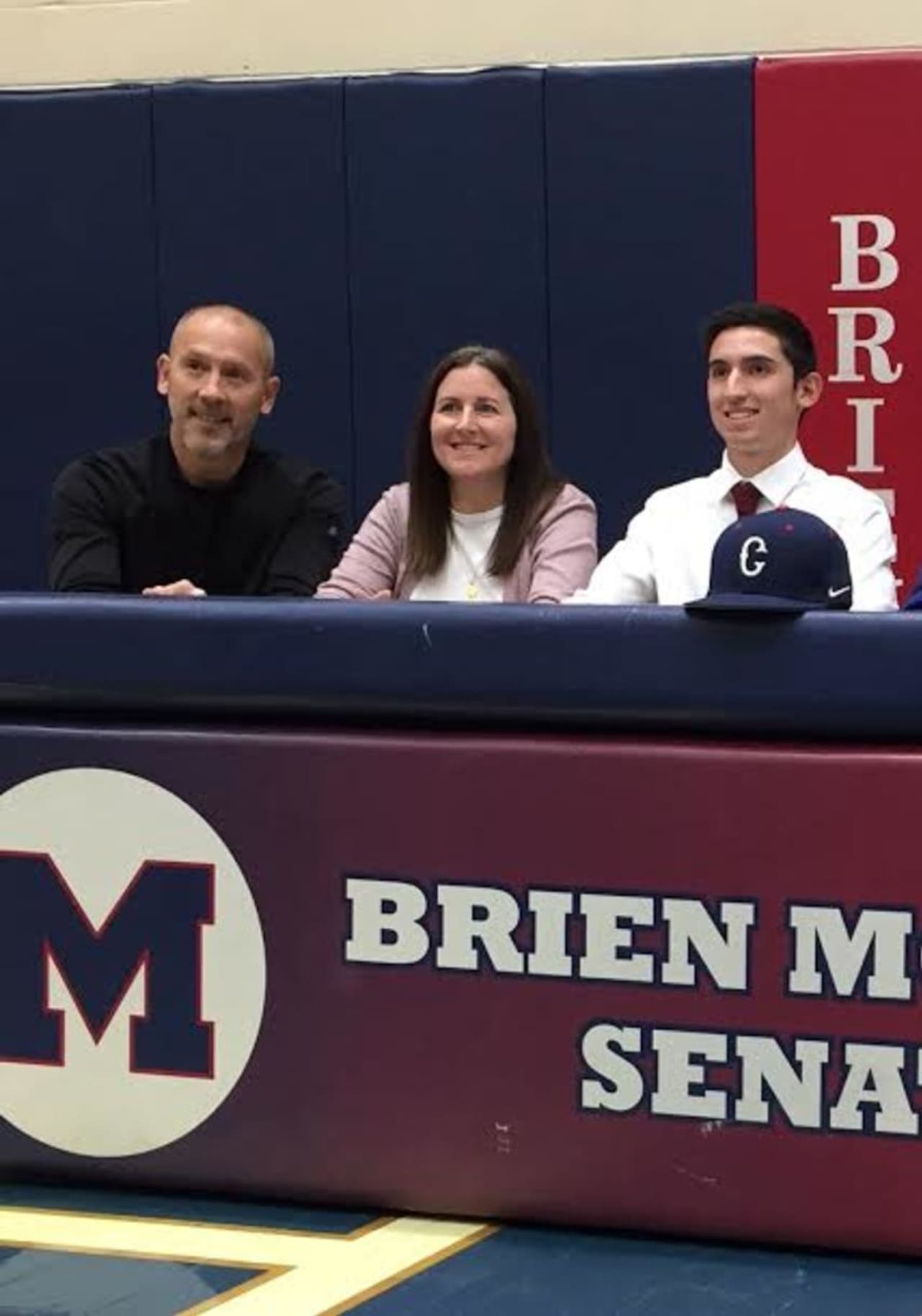 Eric van der Els, right, with his parents Mitch and Lynn, signed a letter of intent earlier this week to continue his distance running career at UConn. 