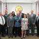 Sgt. Wood with Police Chief Cauwels (far left), Capt. Robert Kneer (far right), Mayor and Council and family.