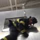 A firefighter exits a simulated window during the training session. 