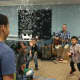 Toddler play with bubbles to the tune of Kurt Gallagher's music at the Maywood Library.