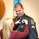 Kim Arnette pins a new badge Weston Police Sgt. Travis Arnette.