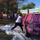 Ramapo High School students take a swing against breast cancer as they destroy a 'pink' car during a fundraiser.