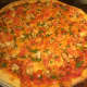 Pollo Pesto pizza made with roasted chicken, tomato, mozzarella cheese and pesto from Sauro's Town Square Pizza Cafe in Patterson.