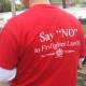 Dozens of protesters wore red shirts on Tuesday that said: "Say 'NO' to Firefighter Layoffs." About 200 people attended a rally outside Port Chester Village Hall and then marched carrying picket signs in support of eight local firefighters.