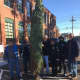 John and Jose of Norwalk Open Door Shelter, Mark, Sgt. Sofia Gulino, Officer Chris Wasilewski and Kevin hoist the tree to it's new home.
