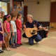 Author Daryl Cobb entertains students at Dows Lane Elementary School with his music and stories.