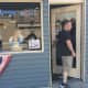 Newly shorn, one of Mark Sinnis' last customers leaves the Beale Street Barber Shop in Peekskill Wednesday.
