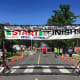 With temps in the high 80s, the finish line must have looked good to runners participating in the John DeMille Firecracker Road Race in Bethel Monday.