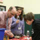 Fourth grader Brendan Xanthos checks his winning Bingo card with Vice Principal Alex Harvey and Principal Paula Bleakley. 