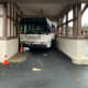 A Westchester Bee-Line bus backed into an overhang at the Scarsdale MTA station.