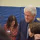 Former President Bill Clinton embraces as supporter while he and his wife, Democratic presidential candidate Hillary Clinton, visiting their polling place in Chappaqua to vote in the New York Democratic primary.