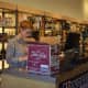 Wine manager Jennifer Young works at the cash register at Kindred Spirits & Wine, a new liquor store on the Post Road in Westport.