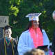 A happy graduate gets her diploma at the Shelton High graduation.