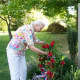 Lynn Watson, of the Green Acres Garden Club, places a wreath at the 9/11 memorial.