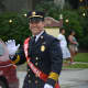 Former Mount Kisco Fire Chief Mario Muccioli marches in the fire department's annual parade as grand marshal.