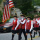 Members of the Mount Kisco Ancient Fife & Drum Corps march in the fire department's parade.