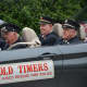 Several of the Mount Kisco Fire Department's "Old Timers" ride in a car for the parade.