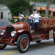 An antique Millwood firetruck is driven in the Mount Kisco Fire Department's parade.
