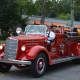 An antique Chappaqua firetruck is driven in the Mount Kisco Fire Department's parade.