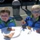 The Country Club at Darien hosted the APTA men's and women's championships over the weekend. Two young boys enjoy their pizza.