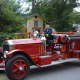 An antique Katonah firetruck is driven in the Mount Kisco Fire Department's annual parade.