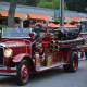 An antique Bedford Hills firetruck is driven in the Mount Kisco Fire Department's annual parade.
