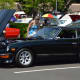 A woman checks out recent model at the Shelton car show on Sunday.