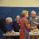 Hillary Clinton chats with an election worker at Chappaqua's Douglas G. Grafflin Elementary School. The building serves as Clinton's polling place for the Democratic presidential primary. Former President Bill Clinton is pictured checking in.