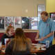 Magician Bryan Lizotte shares a card trick with customers at Magic Cafe in Shelton.