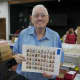 A collector shows off some of his prized stamps at Saturday's show.