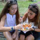 Juliana Mercurio, left, and her mom, Tish Mercurio, both of Allendale, enjoying a Thai combo platter from the Aroy-D truck.