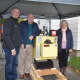 Sam Gault, left, introduced Willie and Anne Salmond to their new home heating system, valued at $11,000.