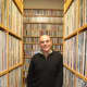 General Manager Steve di Costanzo stands amid the canyons of records ready to be played at WPKN-FM of Bridgeport.